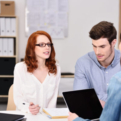 Serious,Young,Business,Professionals,Discussing,Project,Plans,At,The,Table Serious,Young,Business,Professionals,Discussing,Project,Plans,At,The,Table