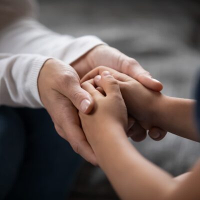 Close,Up,Compassionate,Young,Foster,Parent,Holding,Hands,Of,Little Close,Up,Compassionate,Young,Foster,Parent,Holding,Hands,Of,Little
